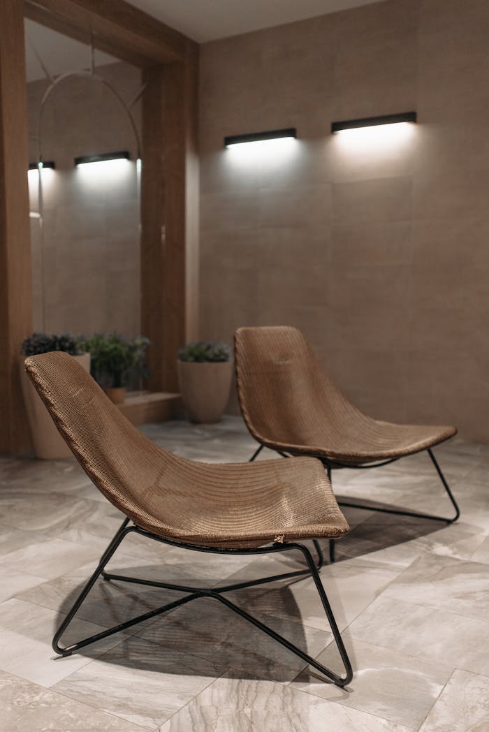 Cozy minimalist room featuring modern chairs with sleek design in a serene setting.